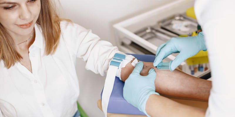 Mature woman getting a blood test in a clinic