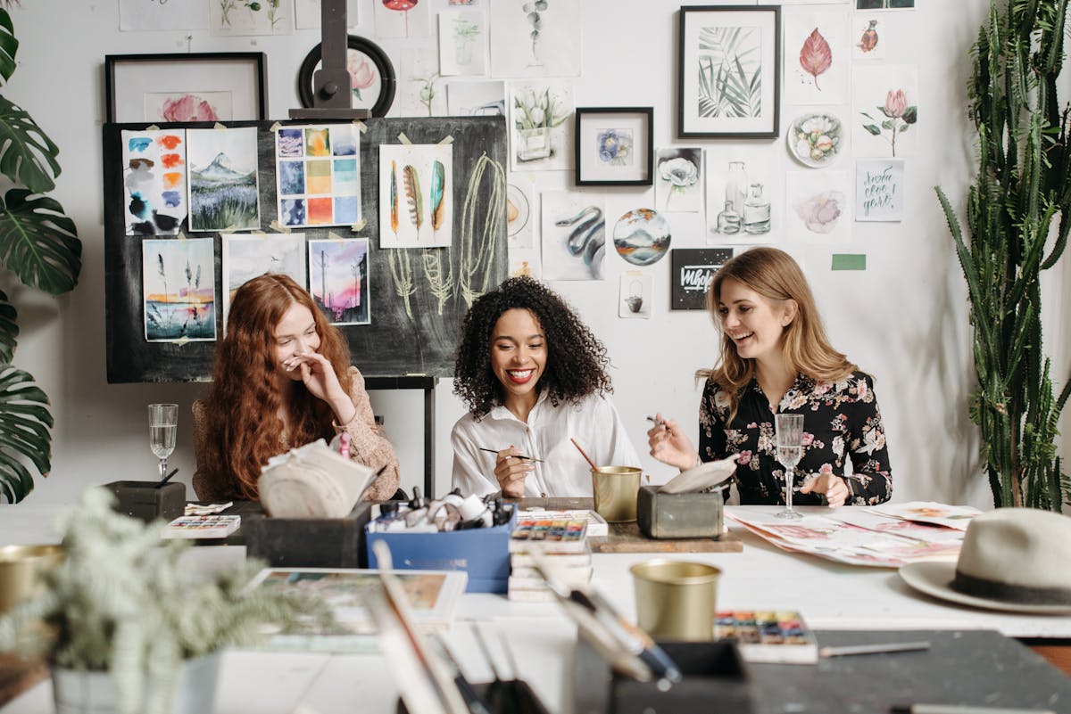 Three women practicing painting in an art class, demonstrating learning and engagement at any age.