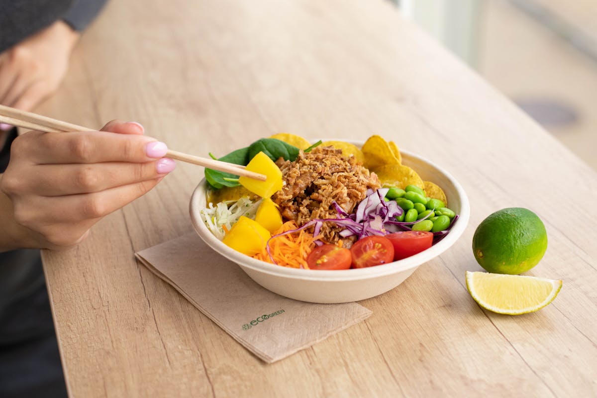 A person eating a fresh salad, illustrating the gut-brain connection through nutritious food choices.