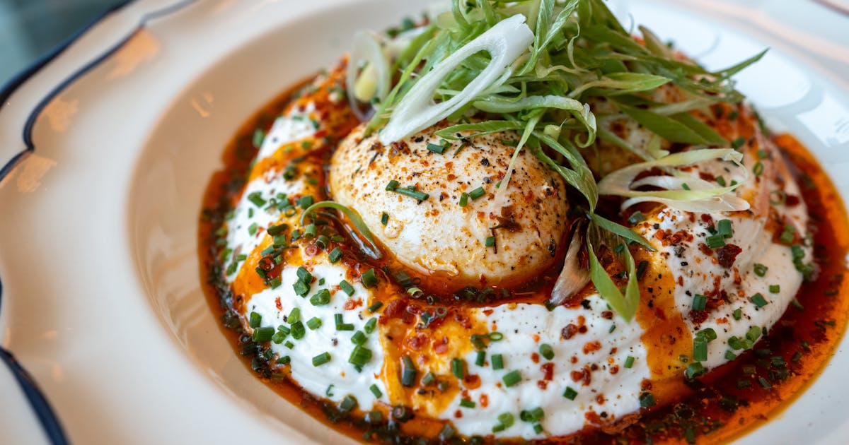 Delicious poached eggs with spiced yogurt on a plate, a high-protein breakfast