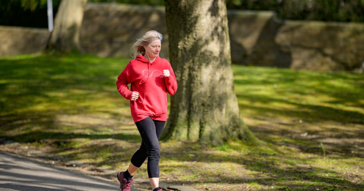 Elderly woman enjoying a healthy outdoor jog in a sunlit park