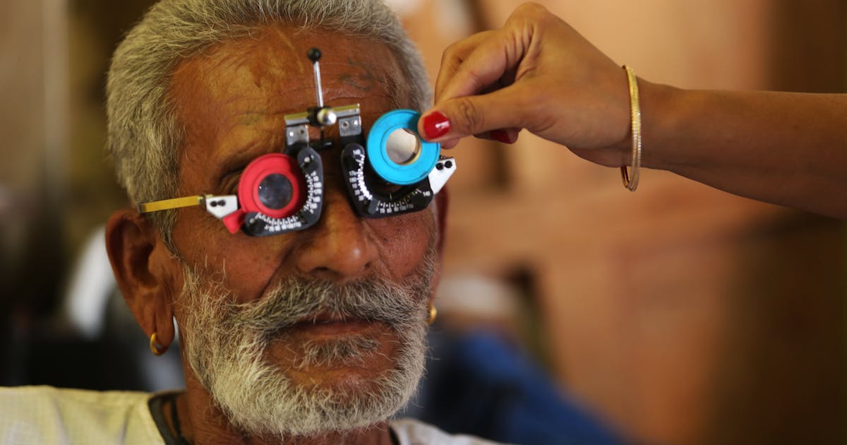 Senior man having vision test with trial lens set during eye exam