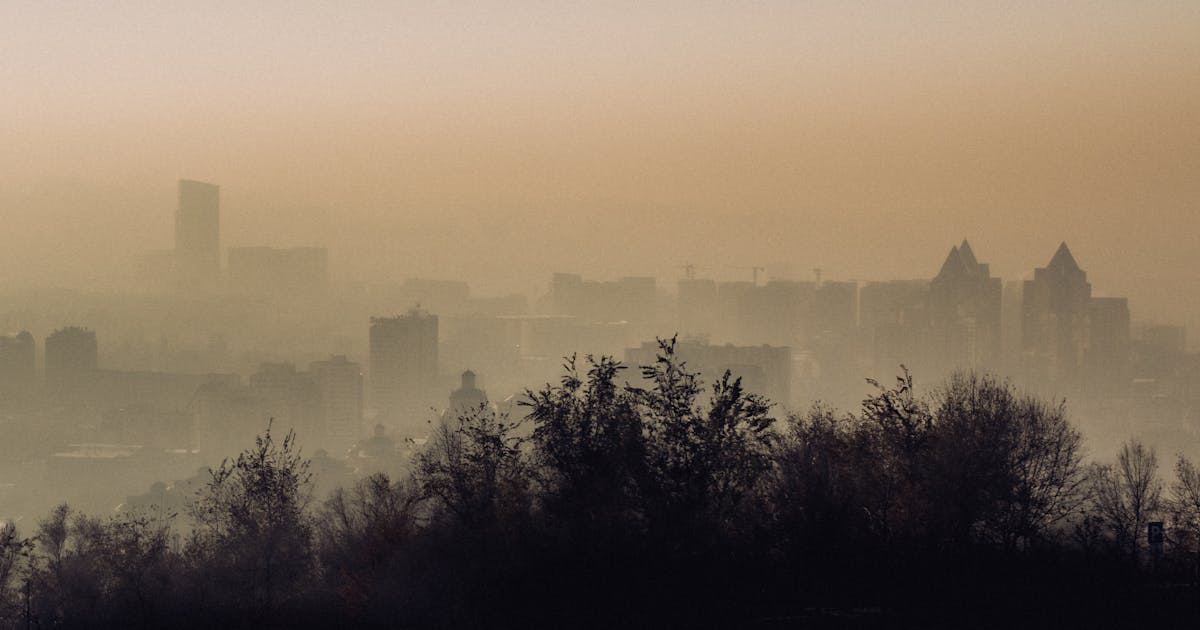 Atmospheric view of Almaty city skyline enveloped in fog and smog