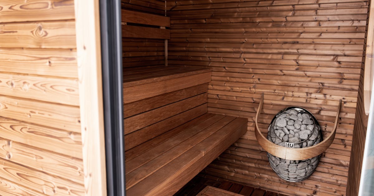 Serene wooden sauna featuring Nordic design and modern electric heater