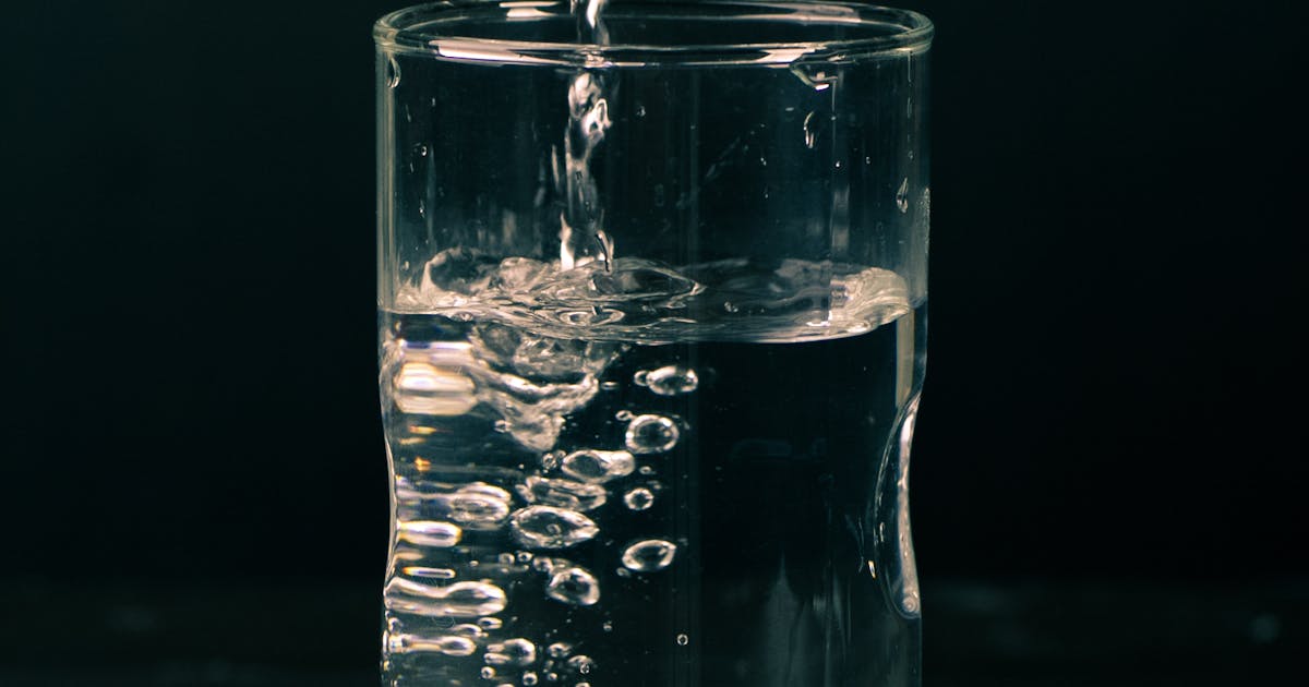 A glass filled with a clear liquid