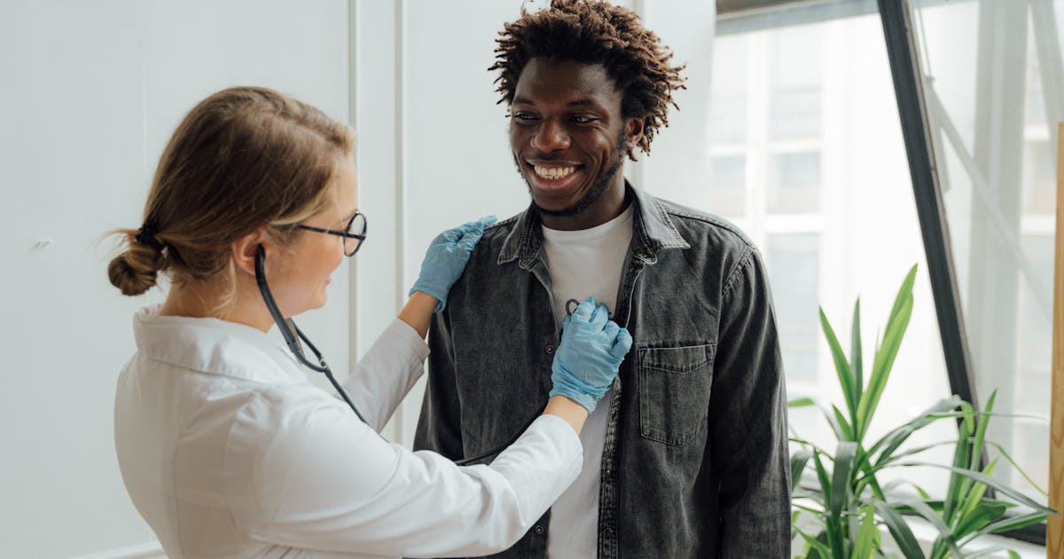 A doctor examining a male patient during a checkup