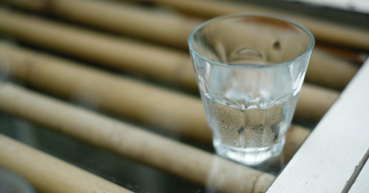 A clear glass of water on a plain background