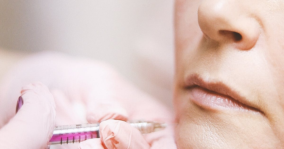A person receiving a cosmetic facial injection at a clinic