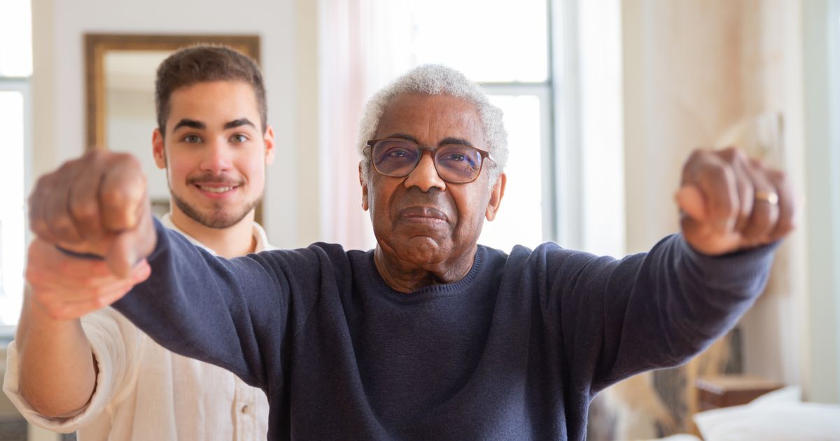 An older adult working with a physical therapist during recovery