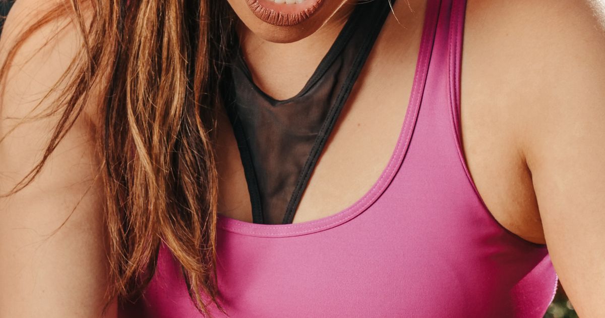 A close-up of a woman holding her knee in pain