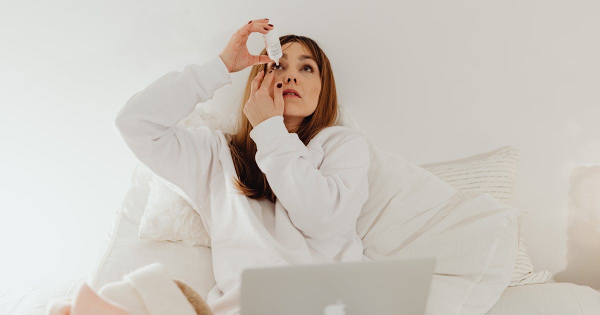 A woman using eye drops