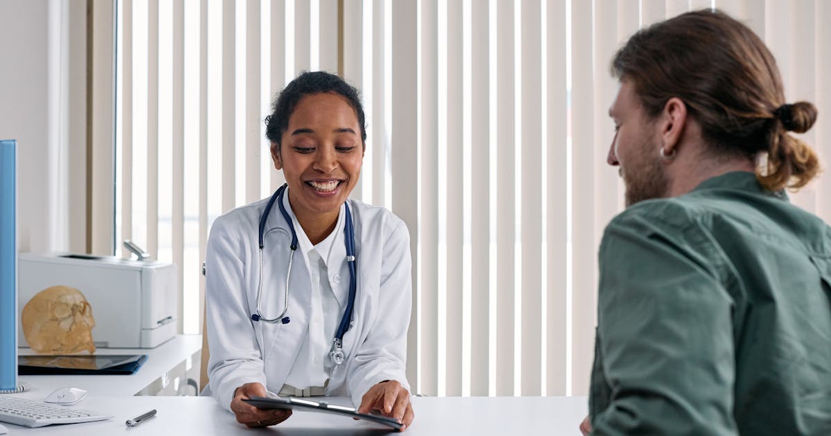 A doctor talking with a patient during a consultation