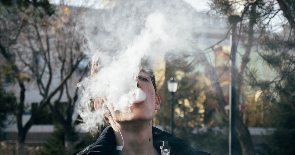 A man using a vape device