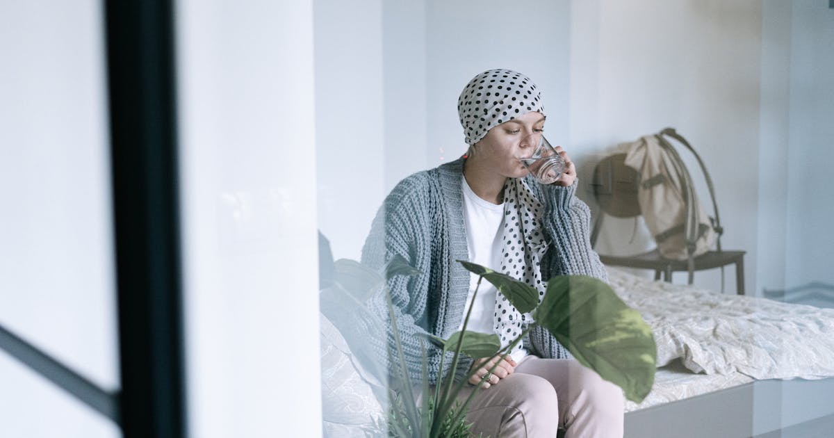 A woman drinking a glass of water