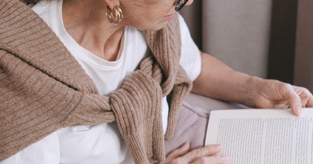 An elderly woman reading a book