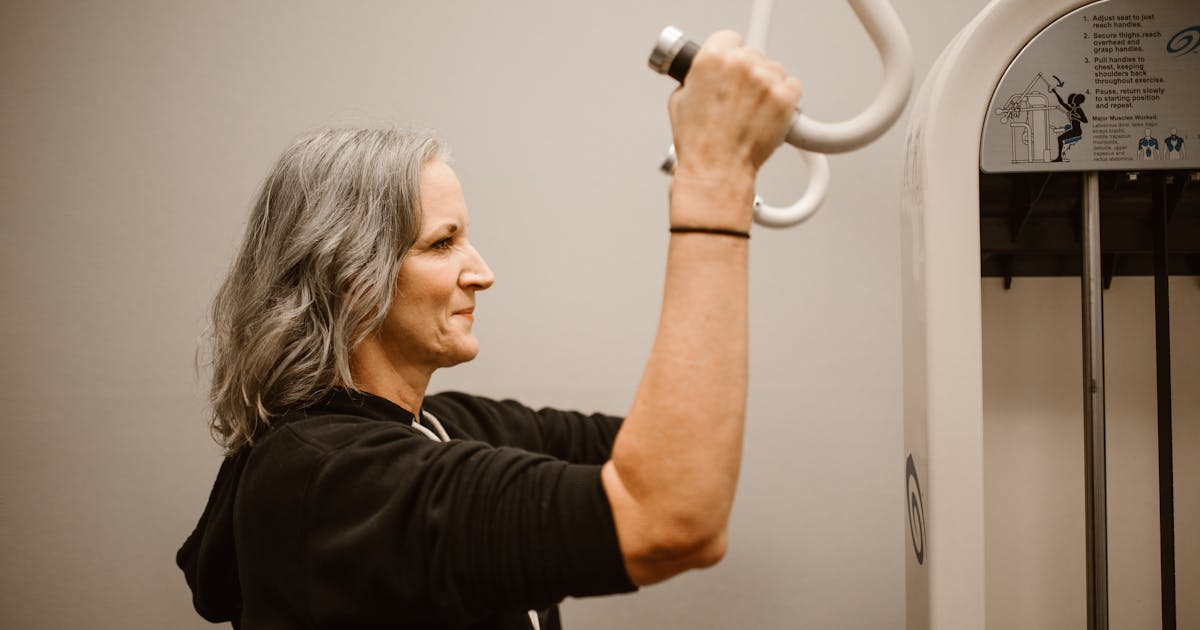 An active older woman exercising with gym equipment