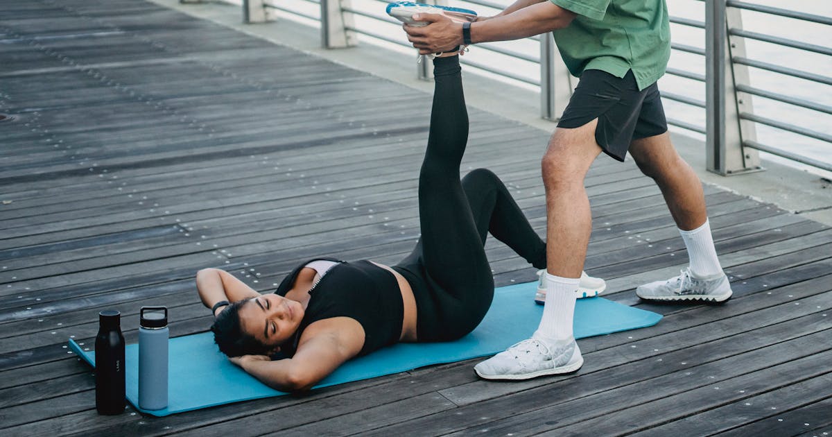 Woman Lying on Yoga Mat Doing Stretching
