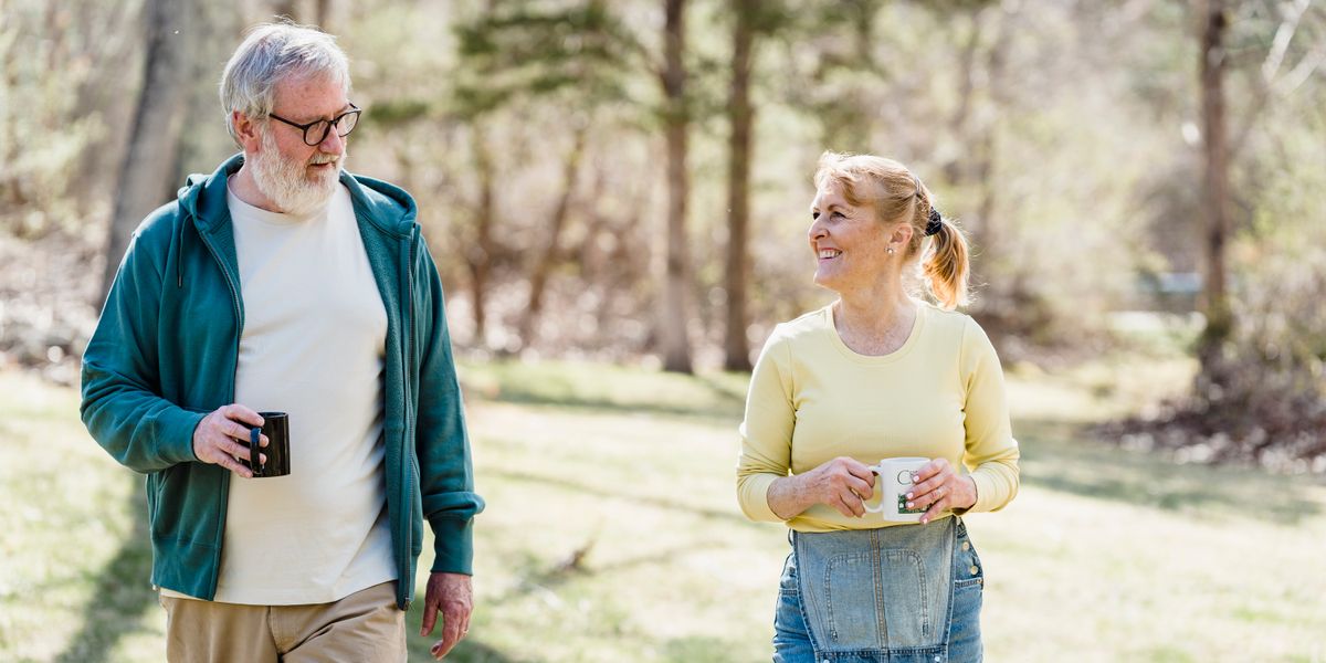 Happy elderly couple walking outdoors, sharing a joyful conversation