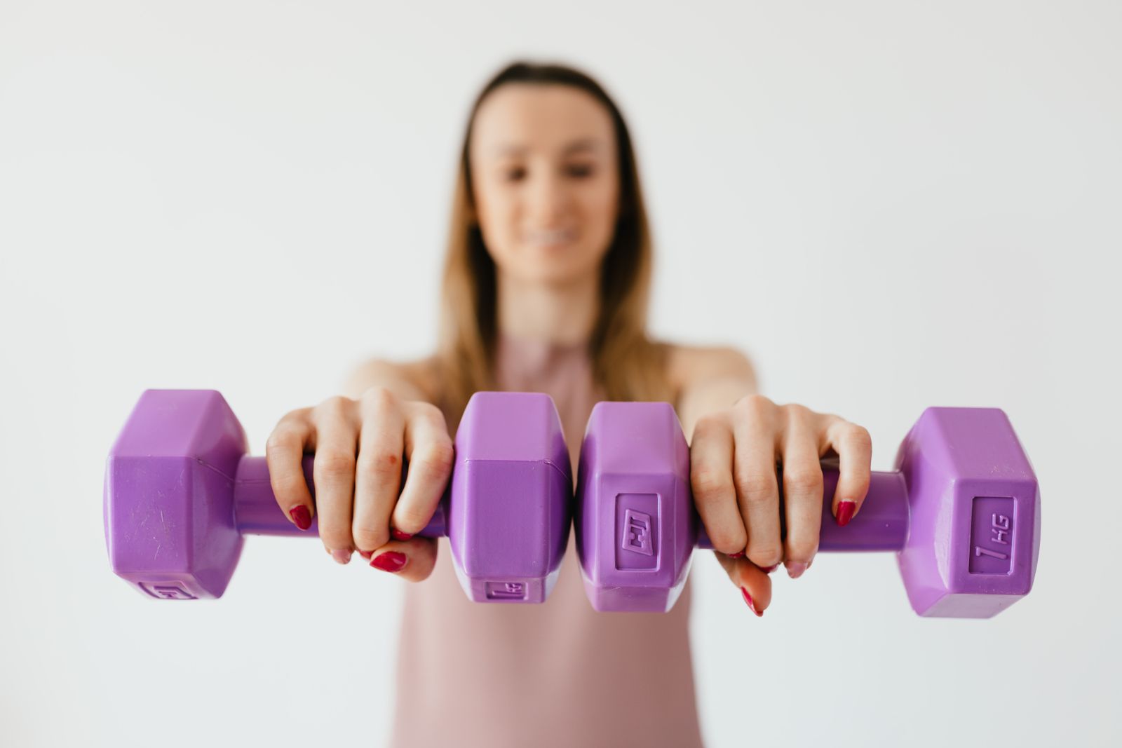 A woman holding dumbbells during a strength workout