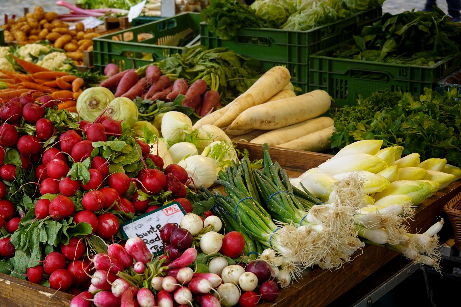 Fresh vegetables and leafy greens on a market stall