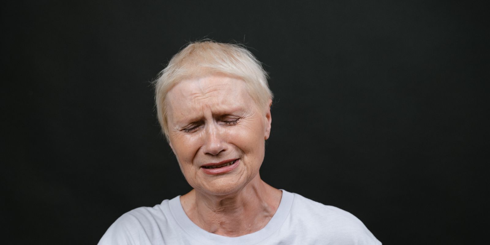 Woman pressing her hand to her chest in pain