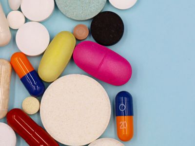 An assortment of colorful multivitamin tablets and capsules