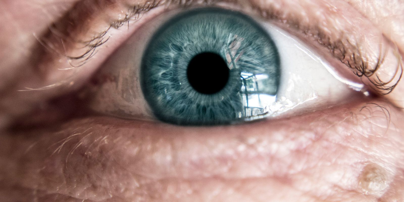 A close view of an older person's blue eye