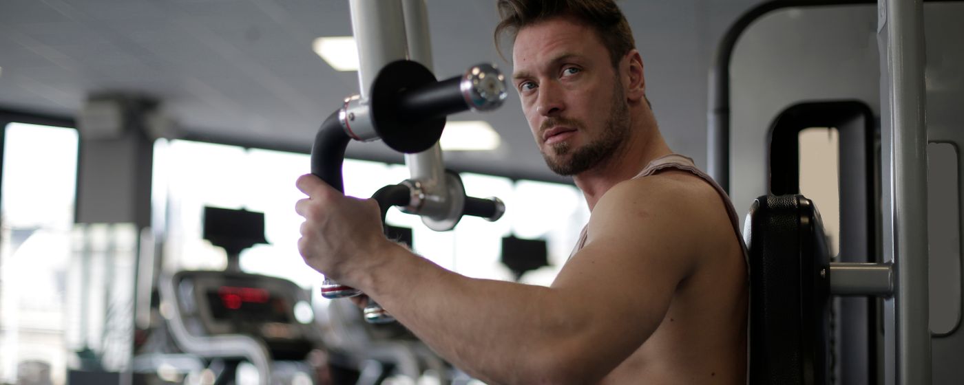 A man using a chest press machine in a gym