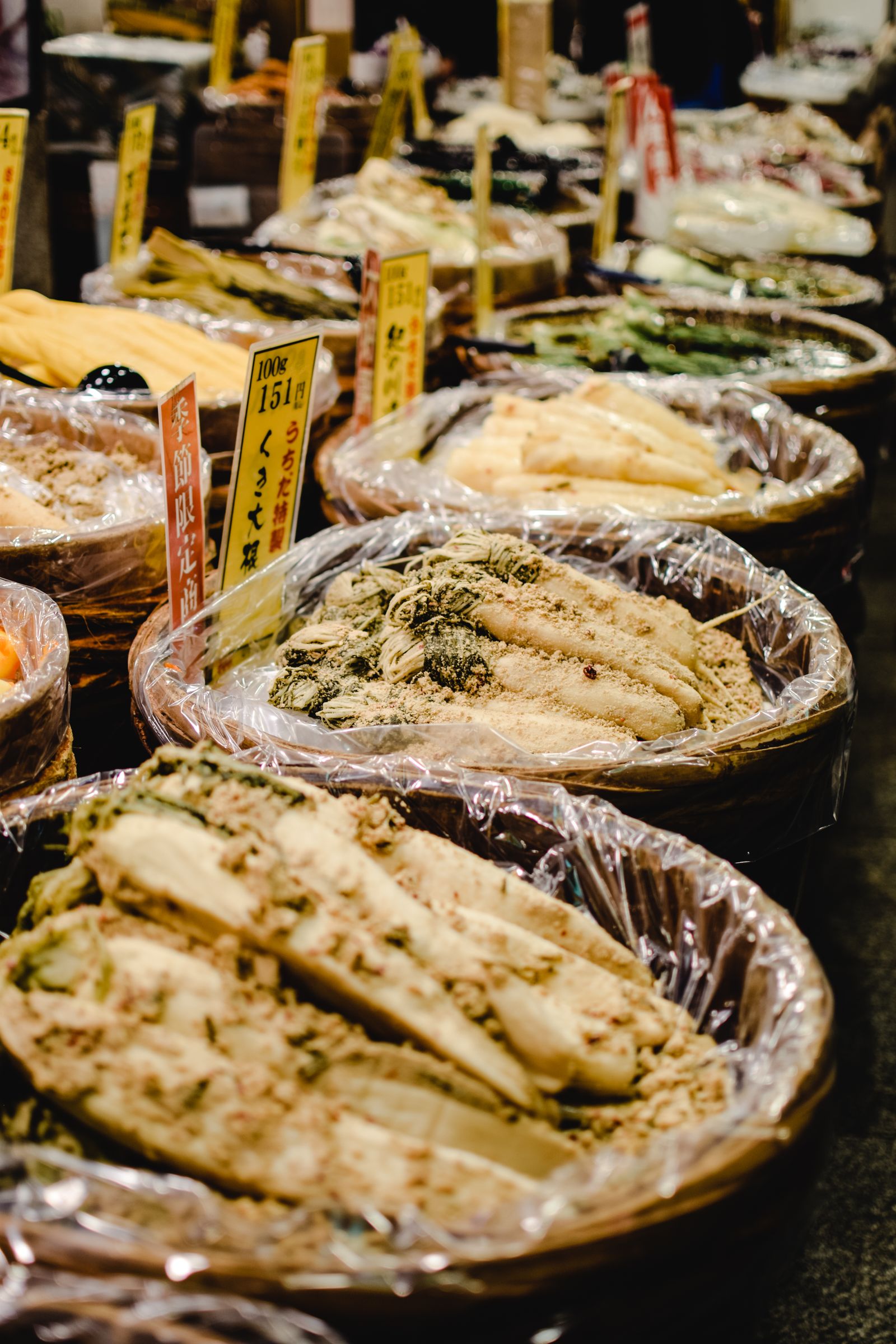 Barrels of fermented pickled vegetables displayed at a market stall