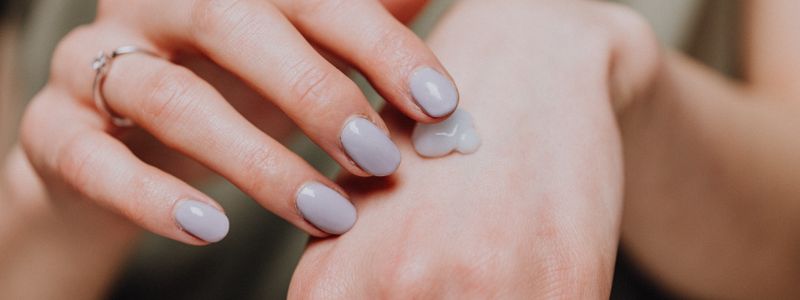 Moisturizer being applied to the back of a hand