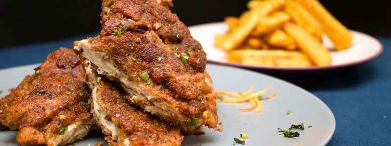 Plates with deep fried meat and french fries