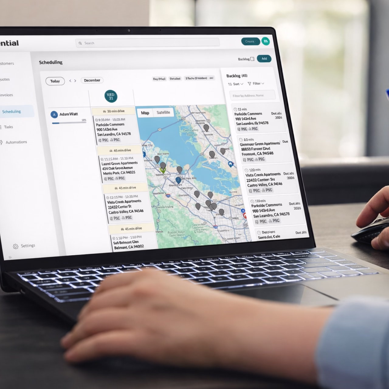 Person using a laptop displaying a scheduling application with a map and a list of locations in the San Francisco Bay Area.