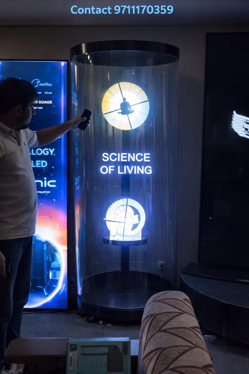 Man pointing a smartphone at an illuminated display case with text 'SCIENCE OF LIVING' and two glowing circular symbols inside.
