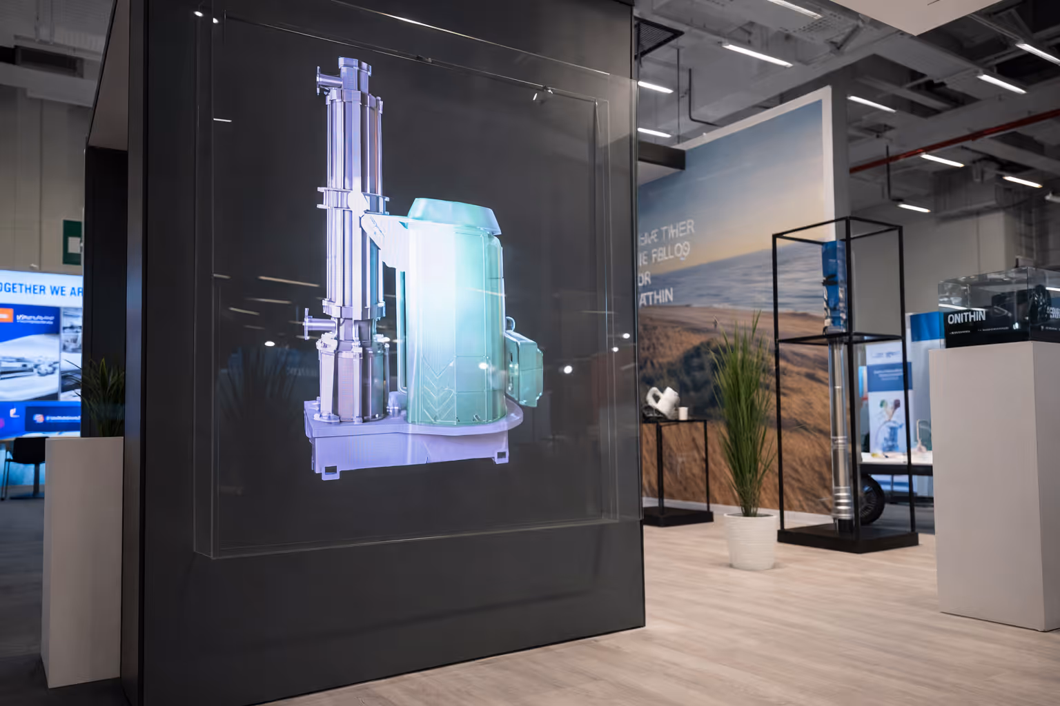 3D holographic display of an industrial machine showcased in a modern exhibition space.