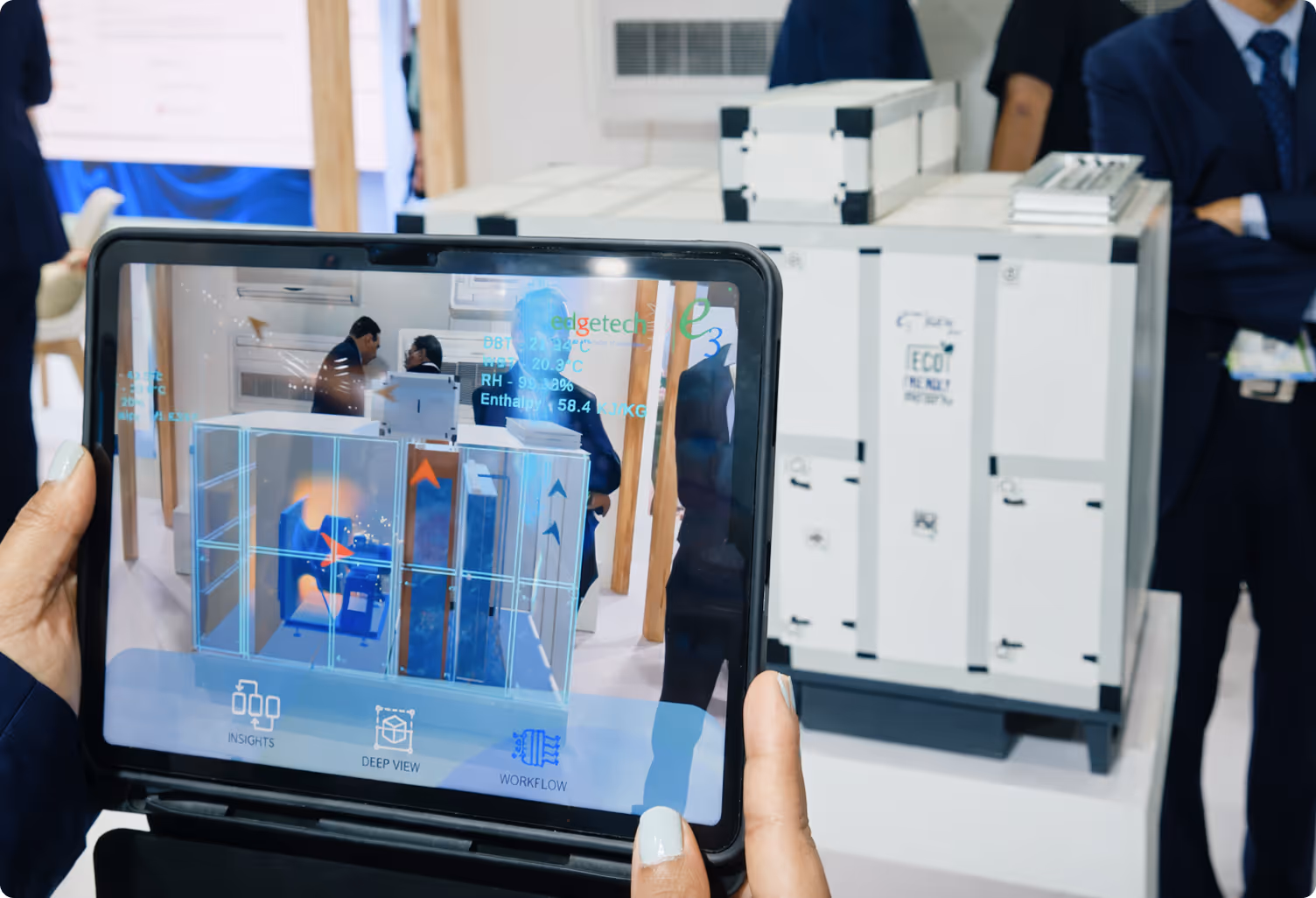 Tablet showing AR HVAC unit display at exhibition