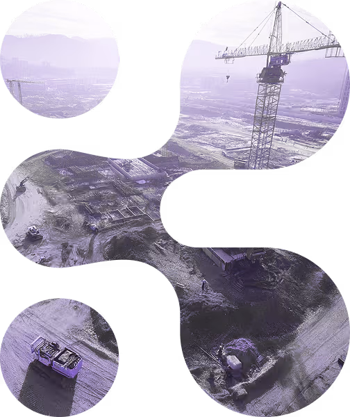 Aerial view of a construction site with a crane and earthmoving equipment on dirt terrain.
