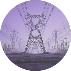 View of large electrical transmission towers and power lines under a purple sky.