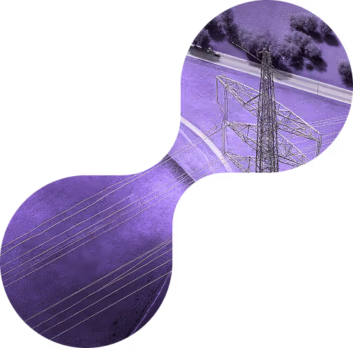 Aerial view of an electrical transmission tower and power lines over a purple-tinted landscape with a road and trees.