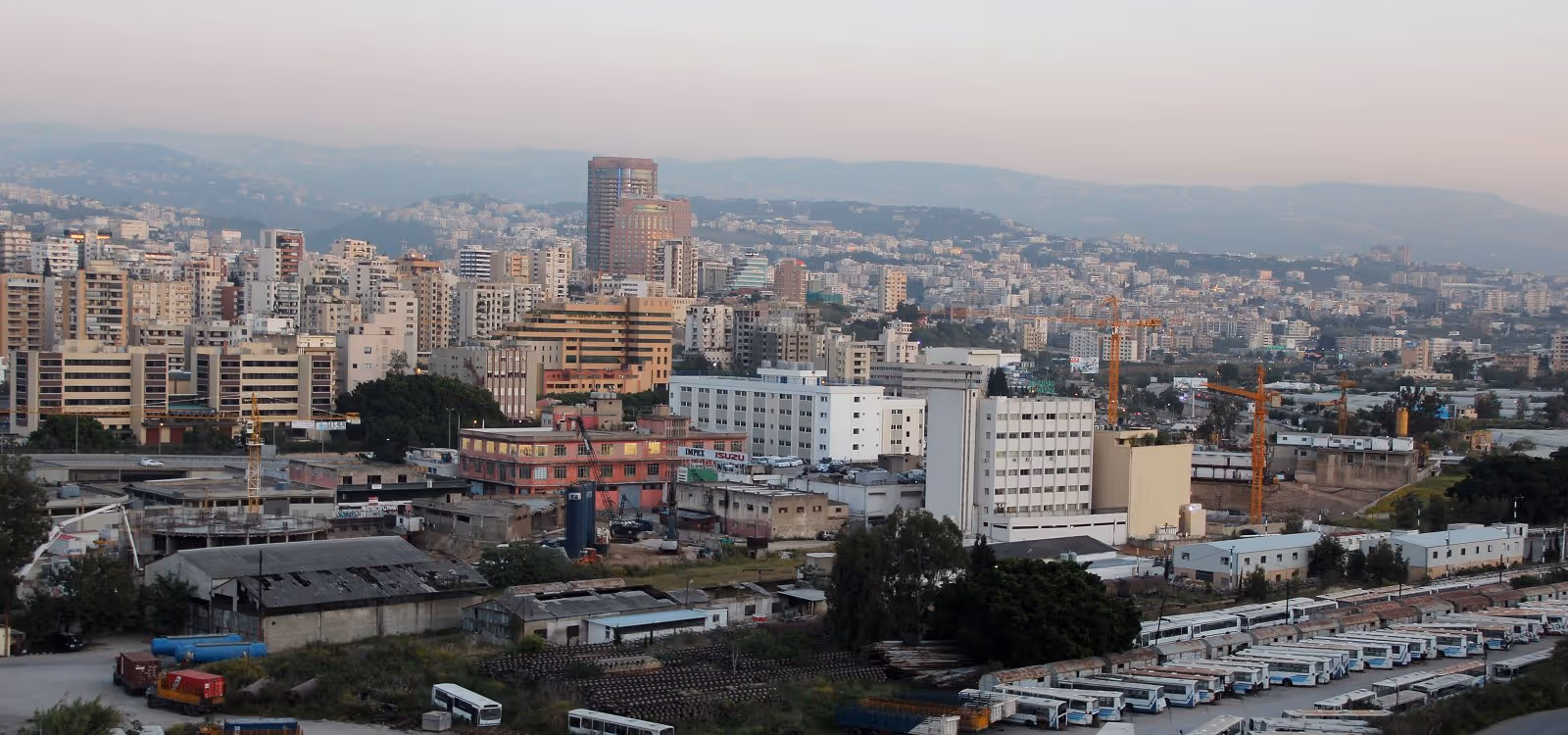 Panoramic view of Beirut cityscape with densely packed buildings and surrounding hills.