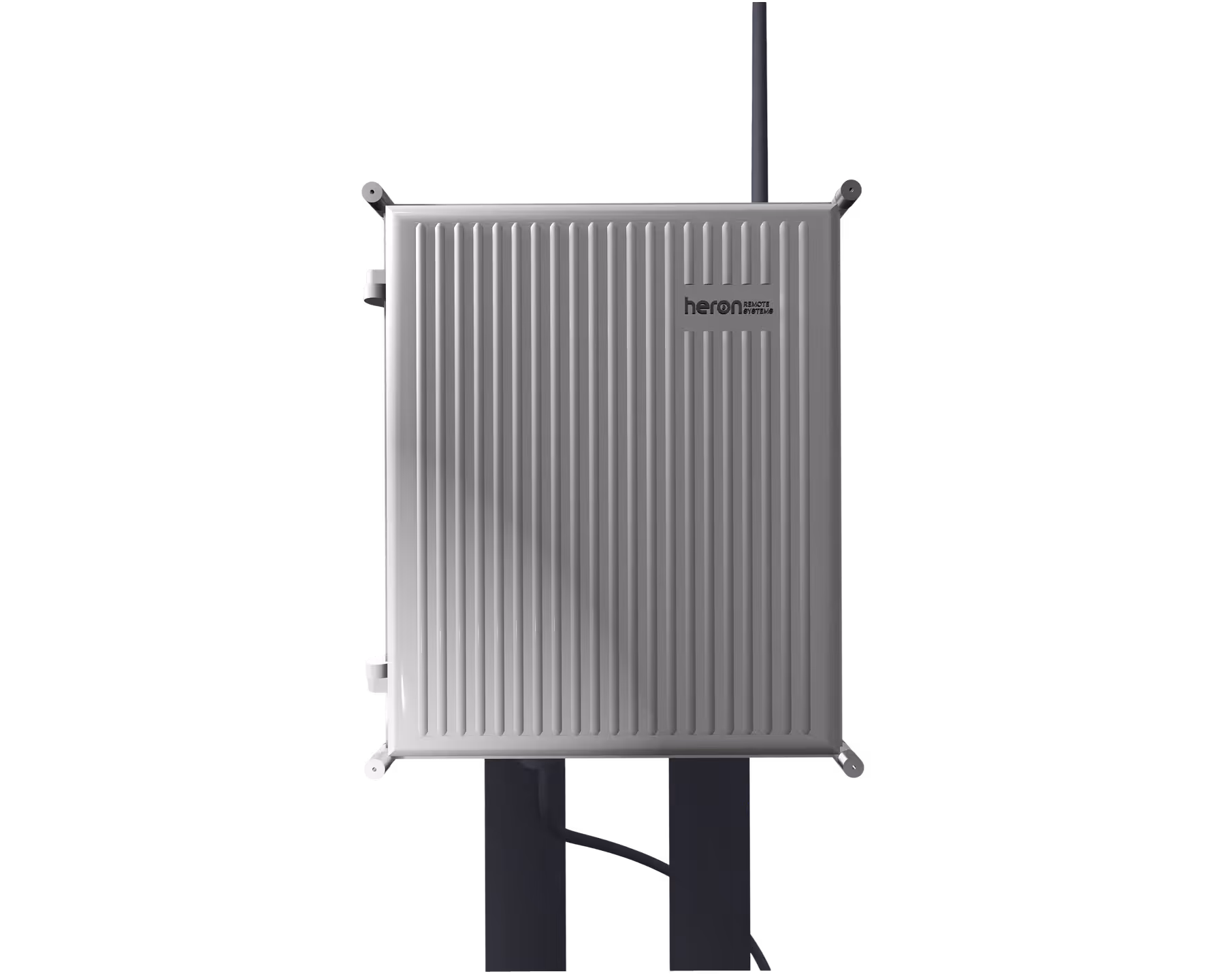 Rectangular gray metal enclosure with vertical ridges and 'heron REMOTE SYSTEMS' logo on top right, mounted with cables attached.