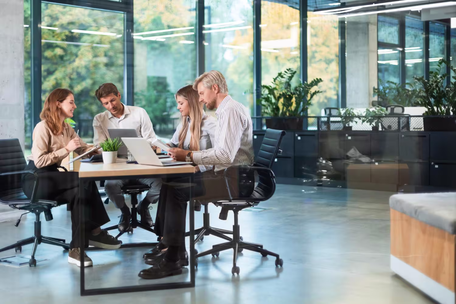 Oracle NetSuite implementation team collaborating at a bright open-plan office table