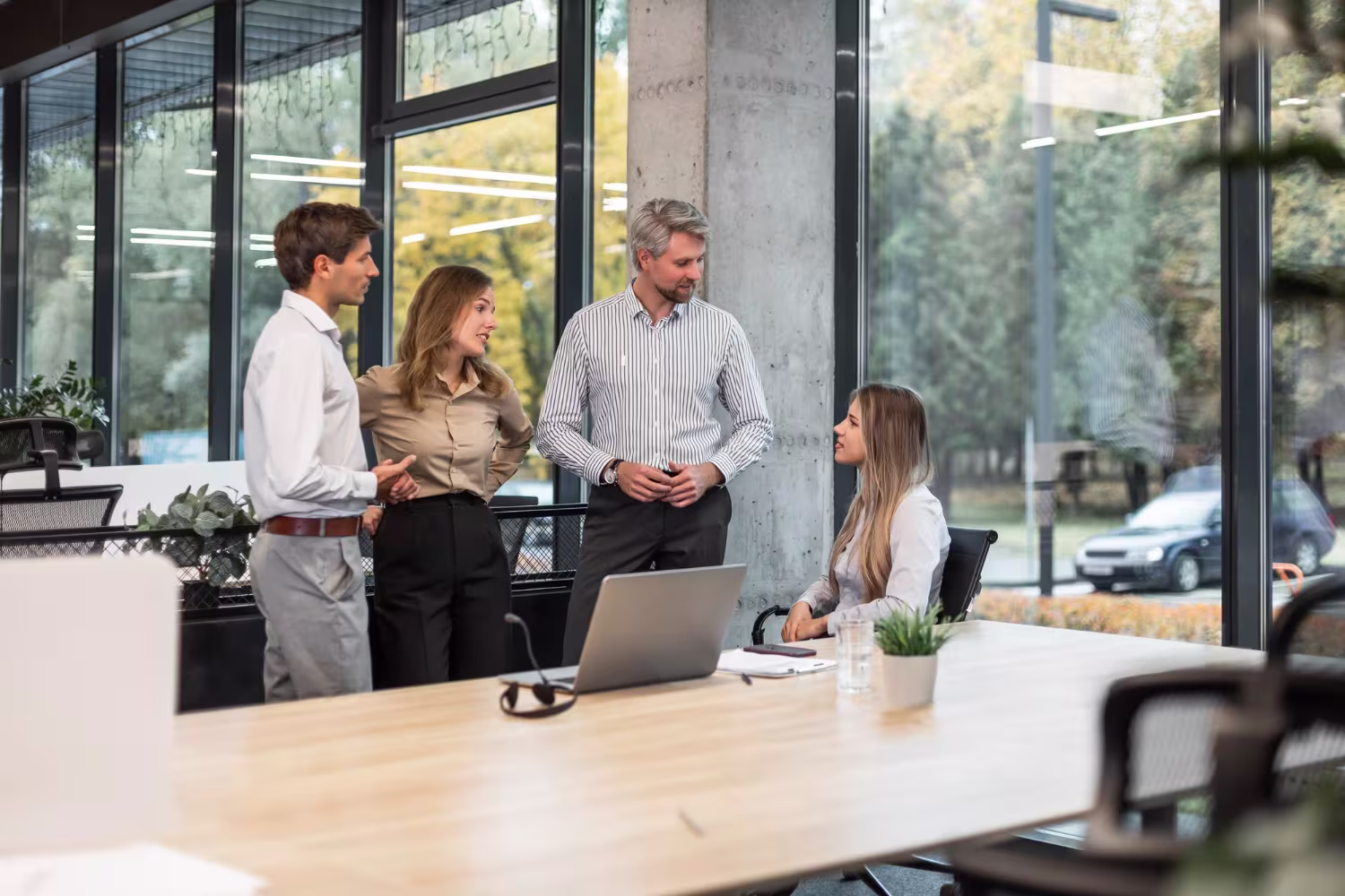 Business consulting team in informal discussion at a modern open-plan office