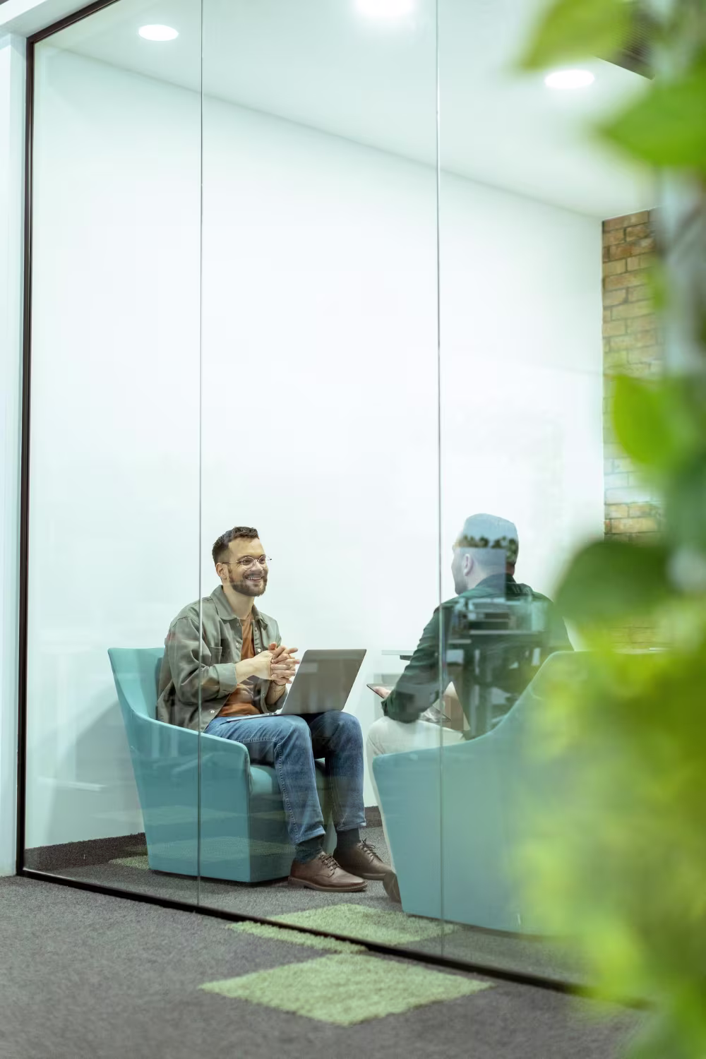 Software or ERP professional working on a laptop in a casual modern workspace pod