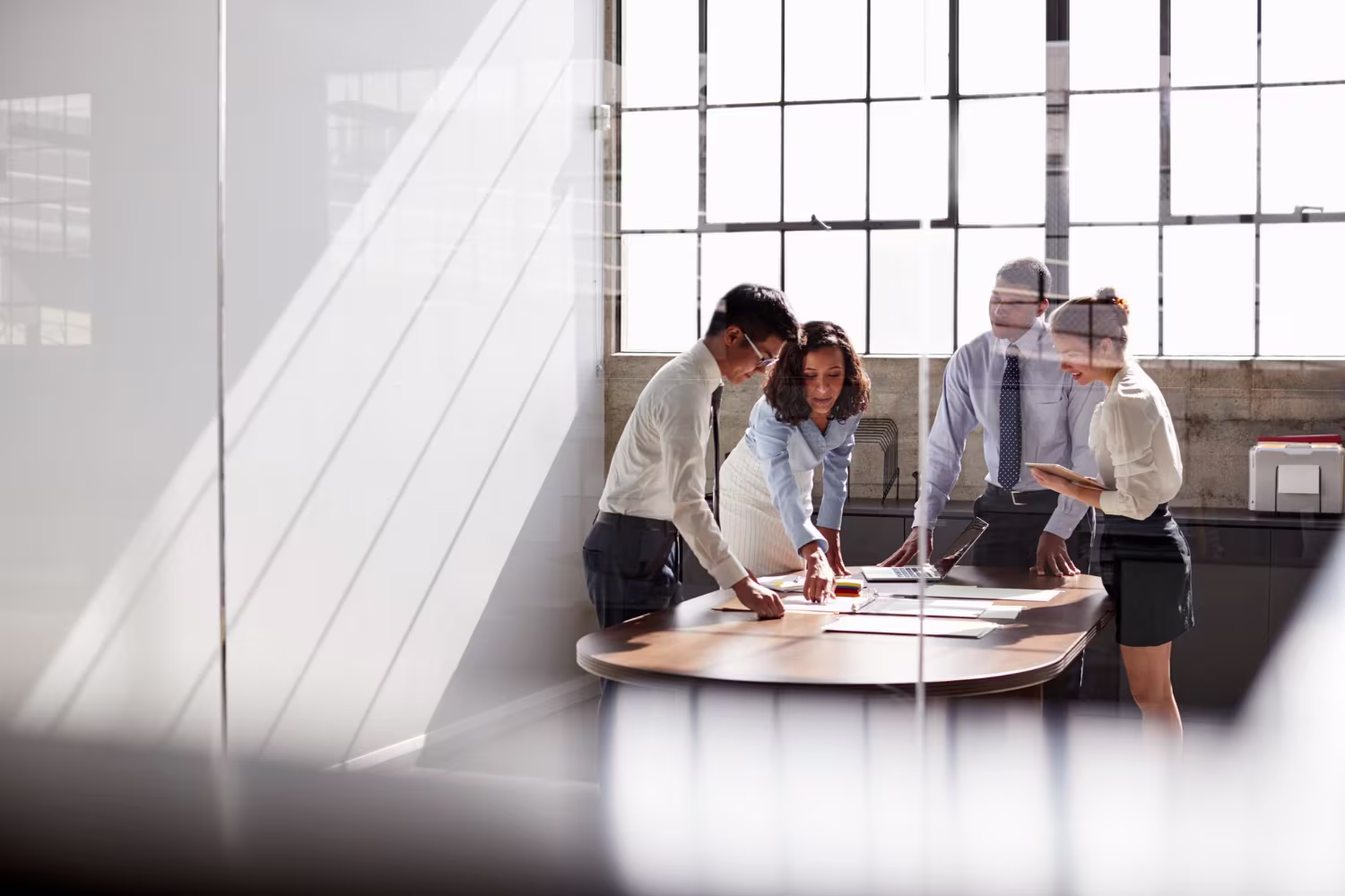 Business team reviewing project plans and documents together at a round table
