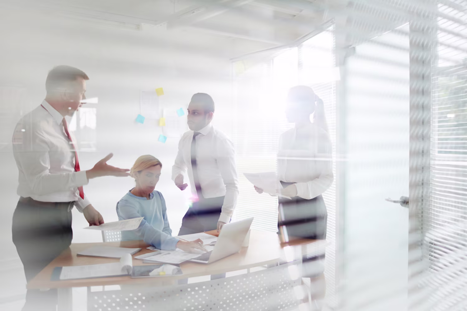 Business team reviewing documents and discussing strategy in a bright modern office