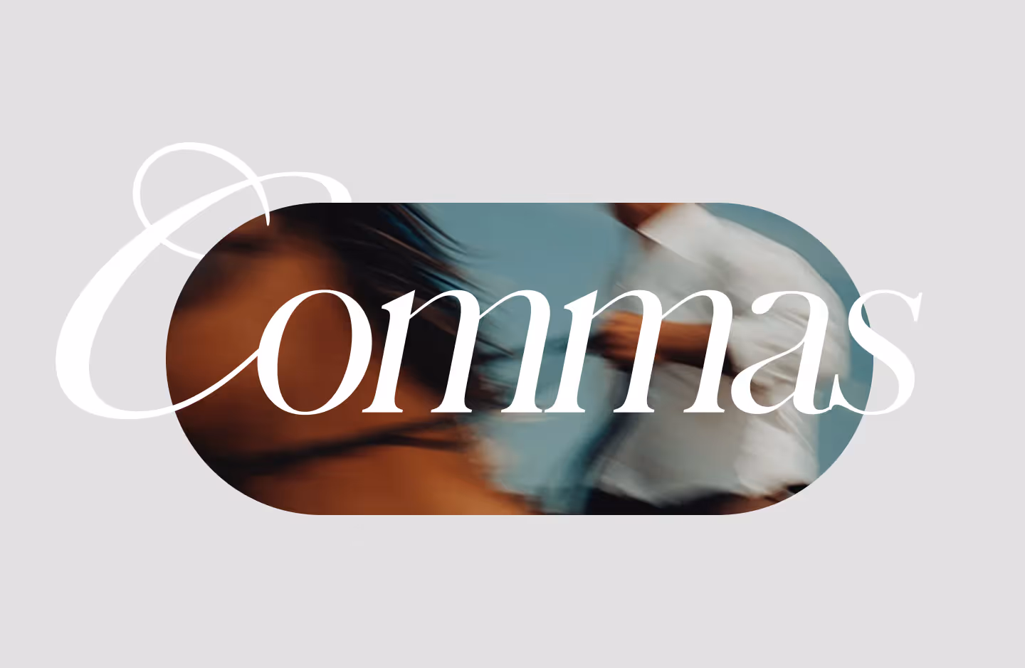 Blurred image of a woman and a man in motion with the word 'Commas' in large white stylish font overlaying the image.