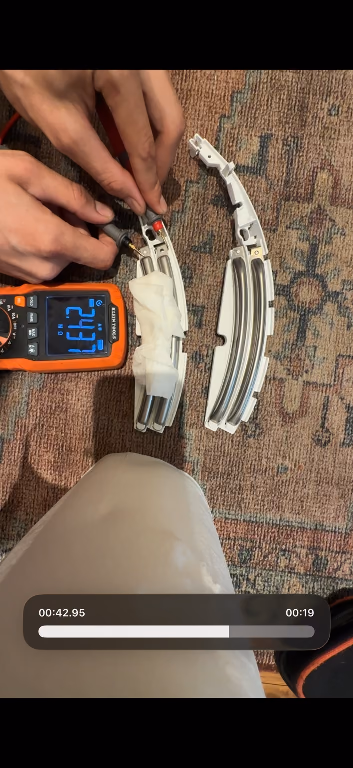 Meter showing 2.437 megaohms across the original Bosch moisture-contact assembly with a damp paper bridge