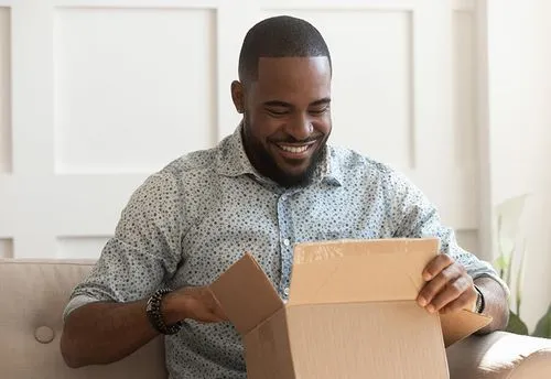 An image of a man opening a right-sized package.