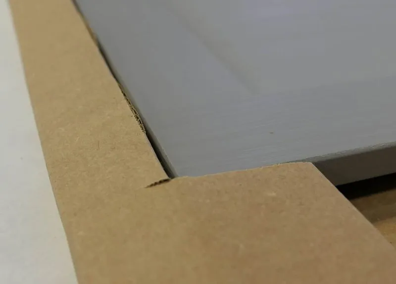 A newly manufactured cabinet protected with custom cardboard packaging from a Packsize machine.