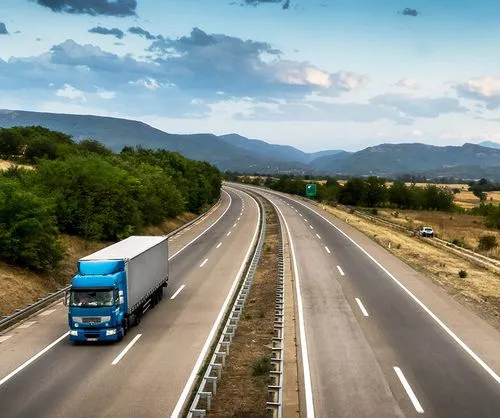 Ein Bild eines Lastwagens, der auf einer Autobahn fährt.